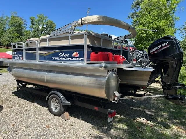 Slide: The Image of 2023 Sun Tracker Bass Buggy 16 XL Select pontoon boat with Mercury engine on trailer. - 25