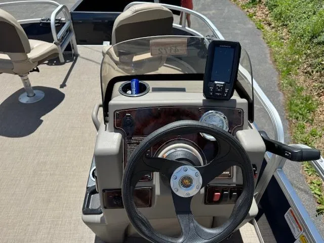 Slide: The Image of 2023 Sun Tracker Bass Buggy 16 XL Select boat dashboard with steering wheel and navigation system. - 6