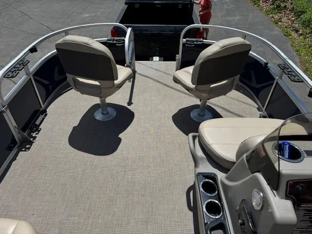 Slide: The Image of 2023 Sun Tracker Bass Buggy 16 XL Select pontoon boat interior with seating and console. - 7