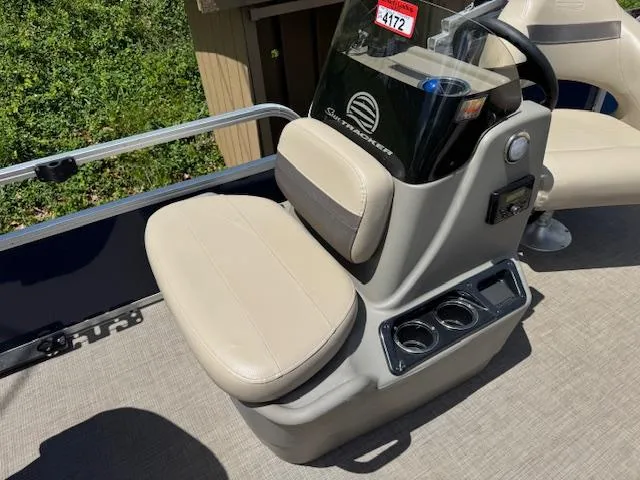 Slide: The Image of 2023 Sun Tracker Bass Buggy 16 XL Select boat console with beige seating and cup holders. - 8