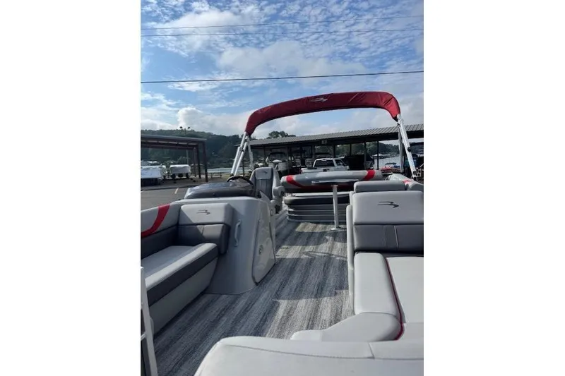 Slide: The Image of 2025 Bennington 22 SSXB pontoon boat with red canopy and spacious seating. - 6
