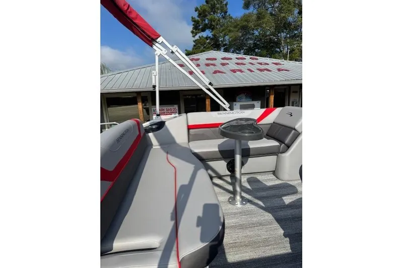 Slide: The Image of 2025 Bennington 22 SSXB pontoon boat with gray and red seating, outdoor setting. - 9