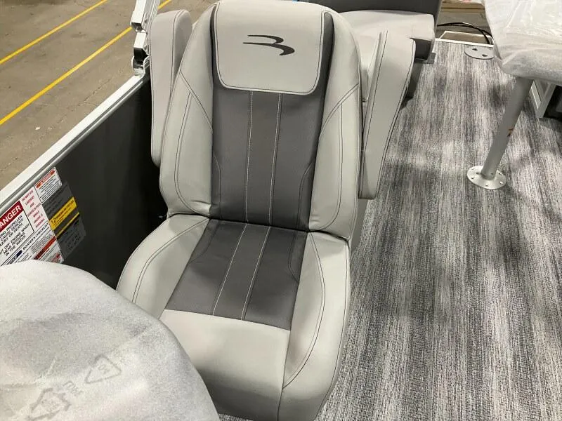 Slide: The Image of 2025 Bennington 22 SSRX boat seat with gray upholstery and logo on carpeted floor. - 6