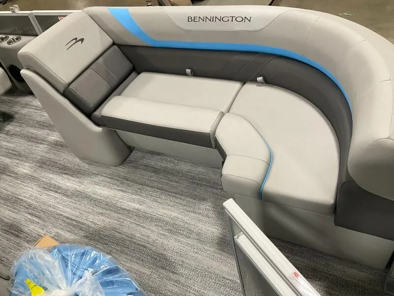 Slide: The Image of 2025 Bennington 22 SSRX boat interior with gray and blue cushioned seating. - 7