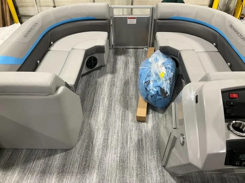 Slide: The Image of 2025 Bennington 22 SSRX pontoon boat interior with gray seating and blue accents. - 8