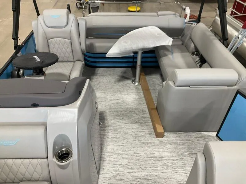 Slide: The Image of 2025 Bennington 22 LSB boat interior with gray seating and a small table. - 7