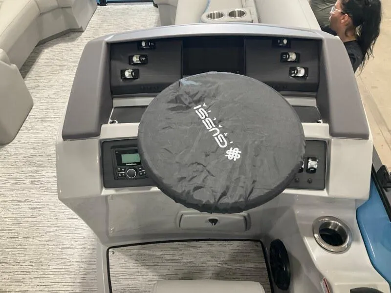 Slide: The Image of 2025 Bennington 22 LSB boat dashboard with covered steering wheel and control panel. - 8