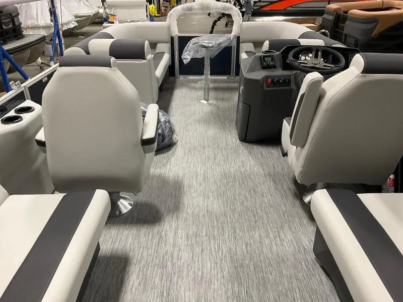 Slide: The Image of 2025 Bennington S 22 SSR pontoon boat interior with modern seating and steering console. - 4