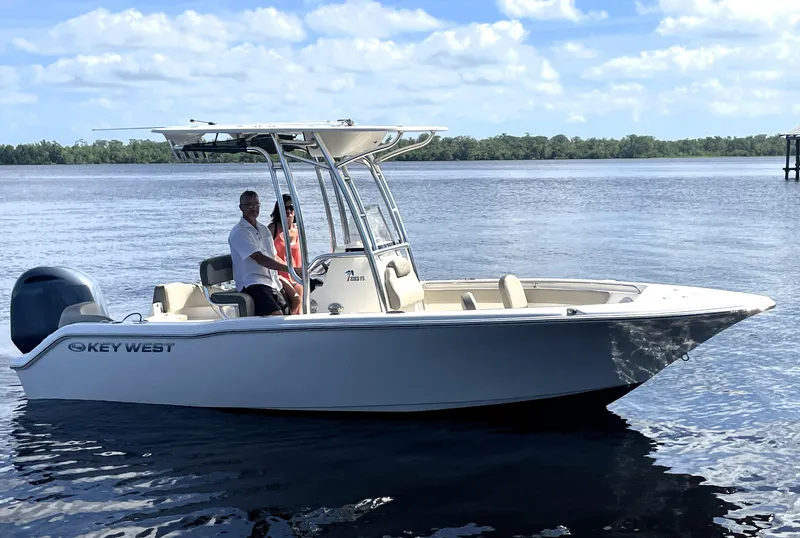 Slide: The Image of 2023 Key West 203 FS boat on calm water with a person onboard. - 0