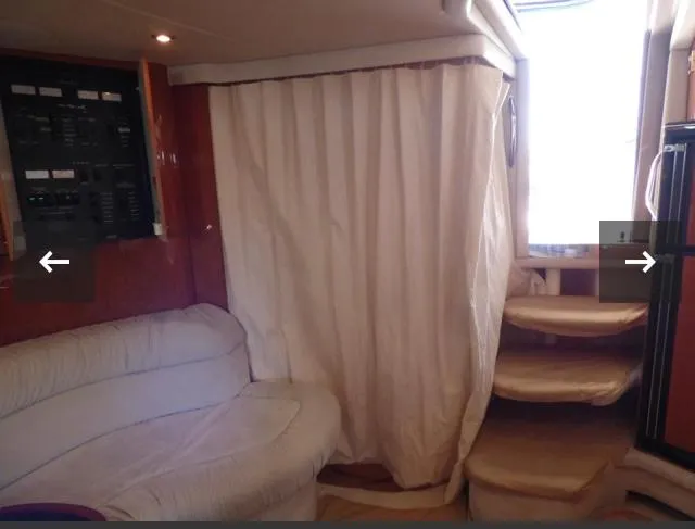 Slide: The Image of Interior of 1999 Sea Ray 380 Sundancer with sofa, curtain, and stairs. - 12