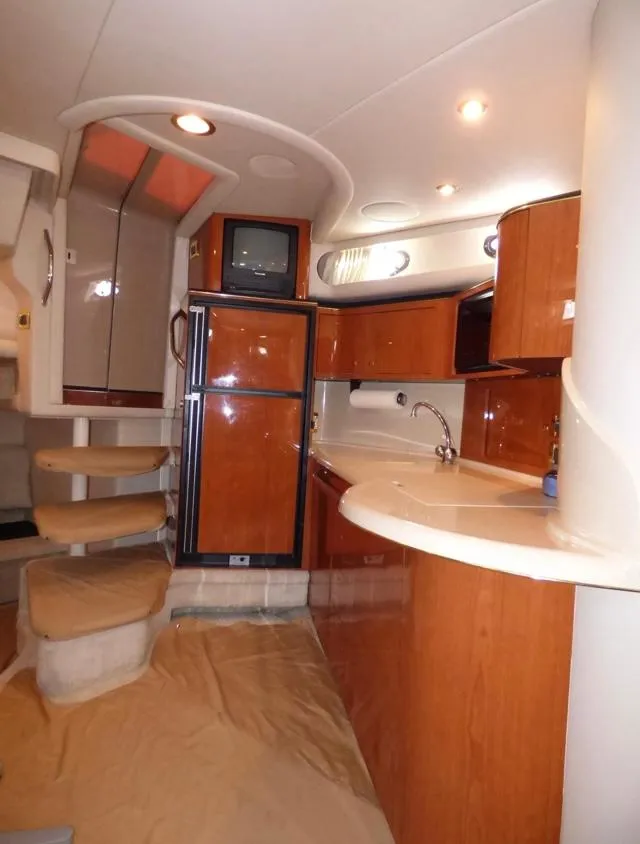 Slide: The Image of Interior of 1999 Sea Ray 380 Sundancer yacht with kitchenette and stairs. - 14