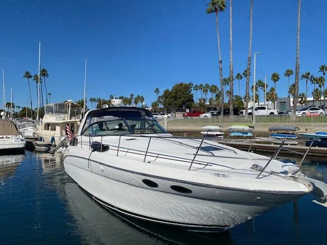 Slide: The Image of 1999 Sea Ray 380 Sundancer yacht docked in a sunny marina with palm trees. - 3