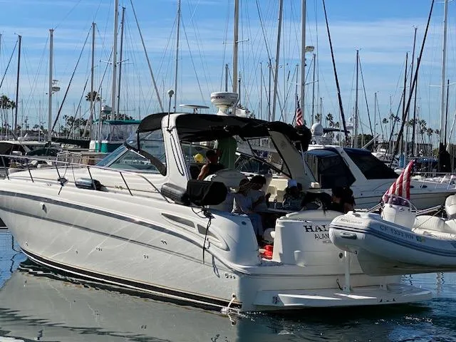Slide: The Image of 1999 Sea Ray 380 Sundancer yacht docked in marina with people onboard. - 4
