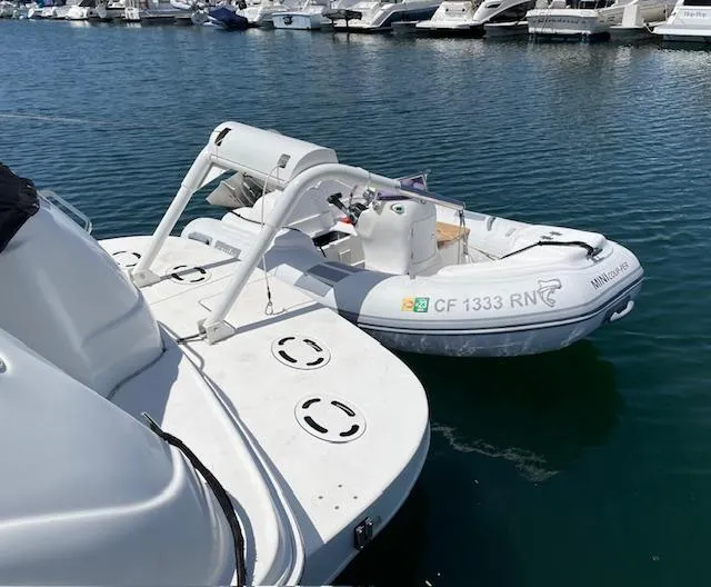 Slide: The Image of 1999 Sea Ray 380 Sundancer docked with inflatable boat on calm water. - 5