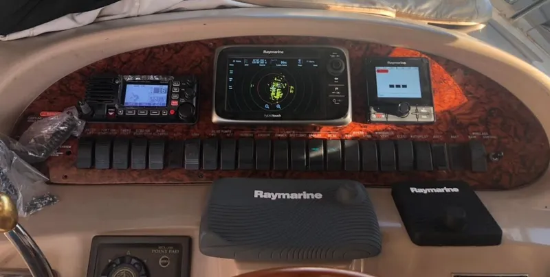 Slide: The Image of Control panel of a 1999 Sea Ray 380 Sundancer with navigation and communication equipment. - 6