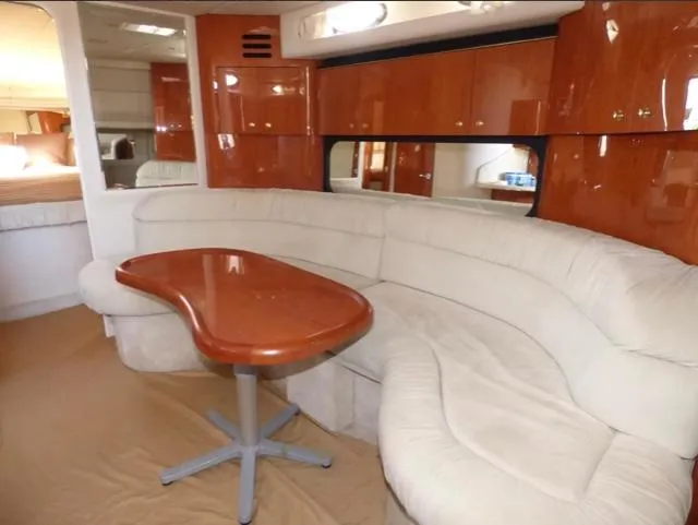 Slide: The Image of Luxurious interior of 1999 Sea Ray 380 Sundancer with plush seating and elegant wood finishes. - 9