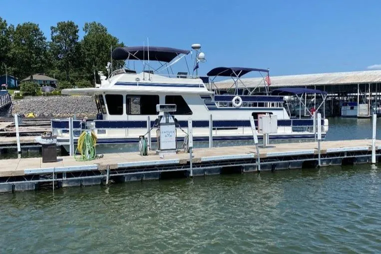 The Image of 2003 Gibson Classic boat docked at a marina on a sunny day. - 0