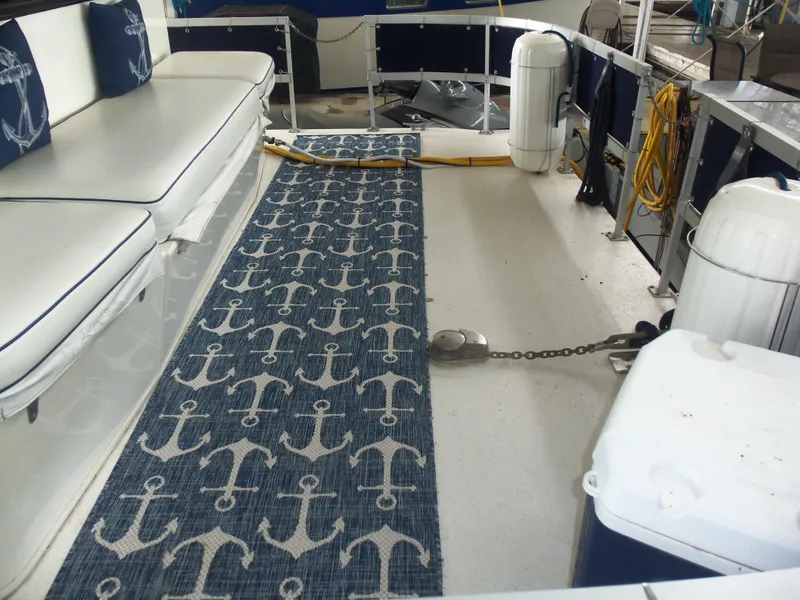 Slide: The Image of 2003 Gibson Classic boat interior with anchor-themed carpet and white seating. - 11