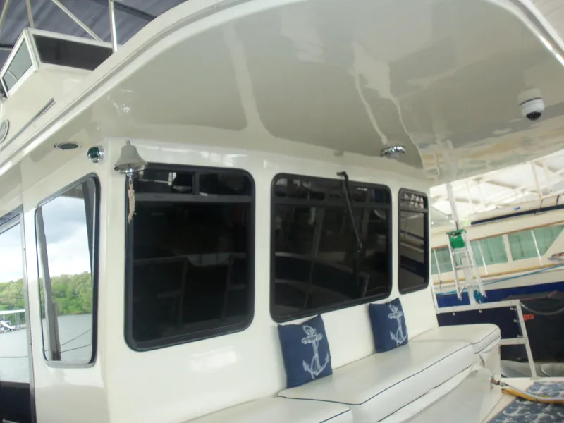 Slide: The Image of 2003 Gibson Classic boat with cushioned seating and nautical-themed pillows on deck. - 12