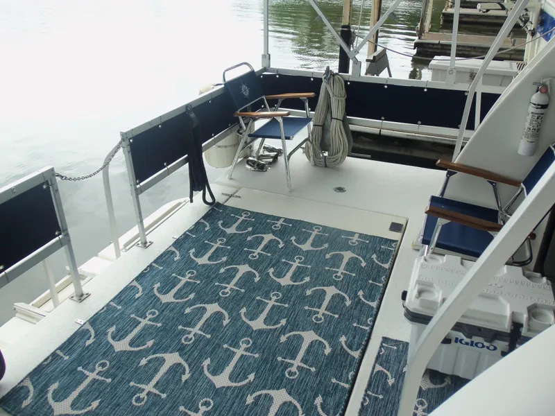 Slide: The Image of 2003 Gibson Classic boat deck with anchor-patterned rug and seating. - 13