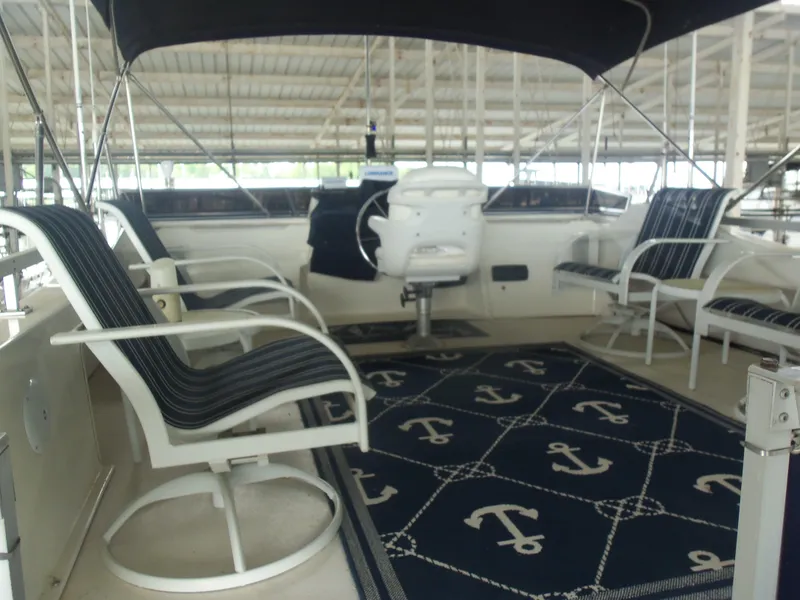 Slide: The Image of 2003 Gibson Classic boat interior with striped seating and anchor-themed rug. - 17