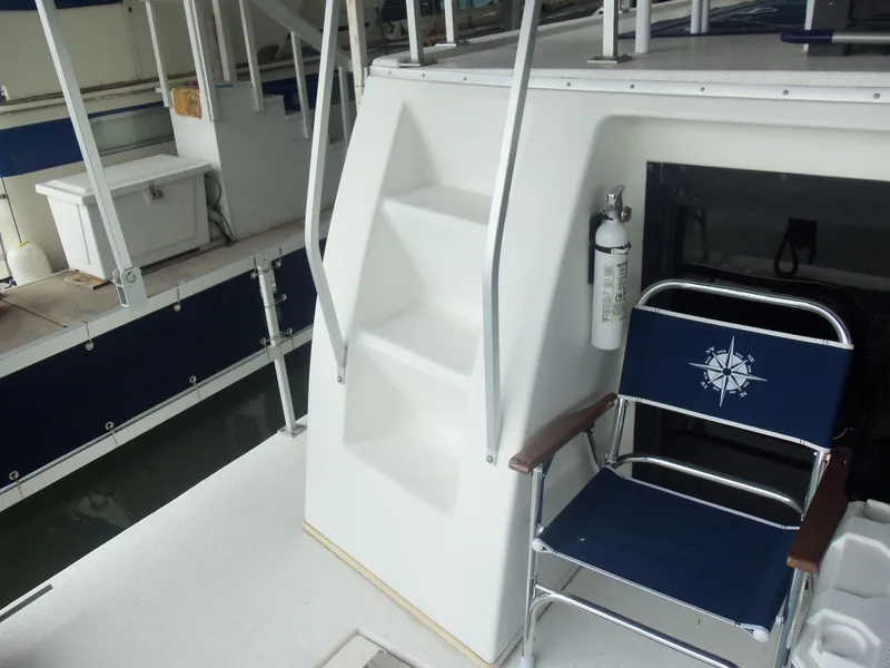 Slide: The Image of 2003 Gibson Classic boat deck with stairs, chair, and fire extinguisher. - 25