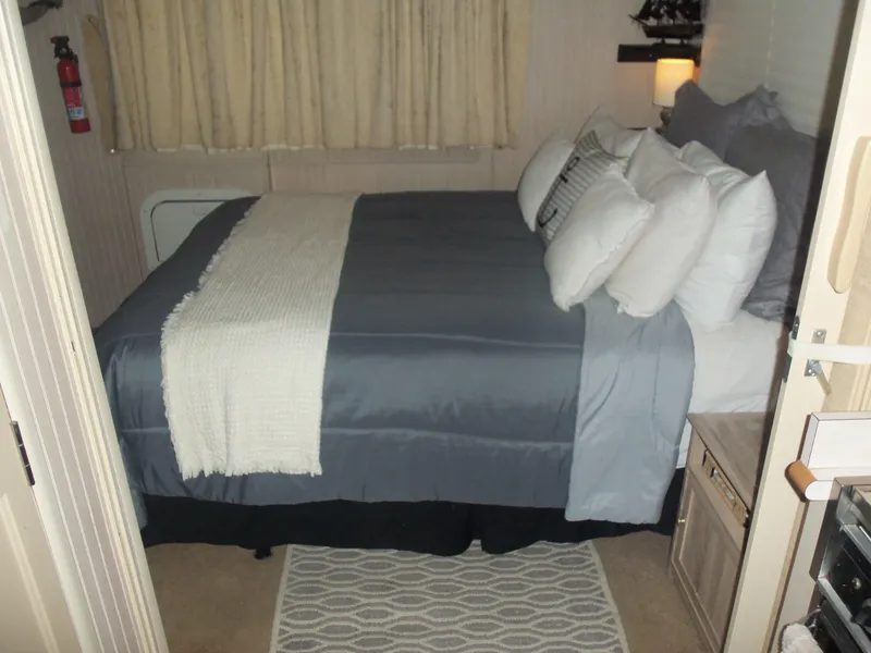 Slide: The Image of Cozy bedroom with a neatly made bed, gray bedding, and decorative pillows. - 37