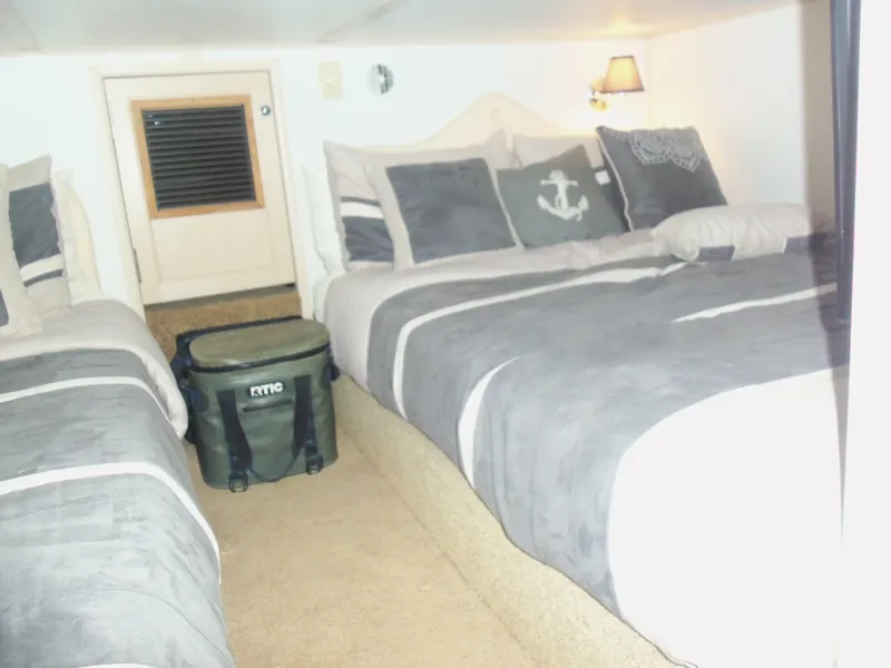 Slide: The Image of Cozy bedroom with twin beds and nautical-themed decor on a 2003 Gibson Classic boat. - 47