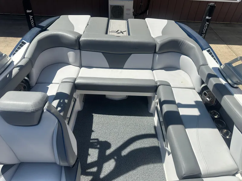 Slide: The Image of 2020 MasterCraft XT20 boat interior with gray and white seating arrangement. - 11