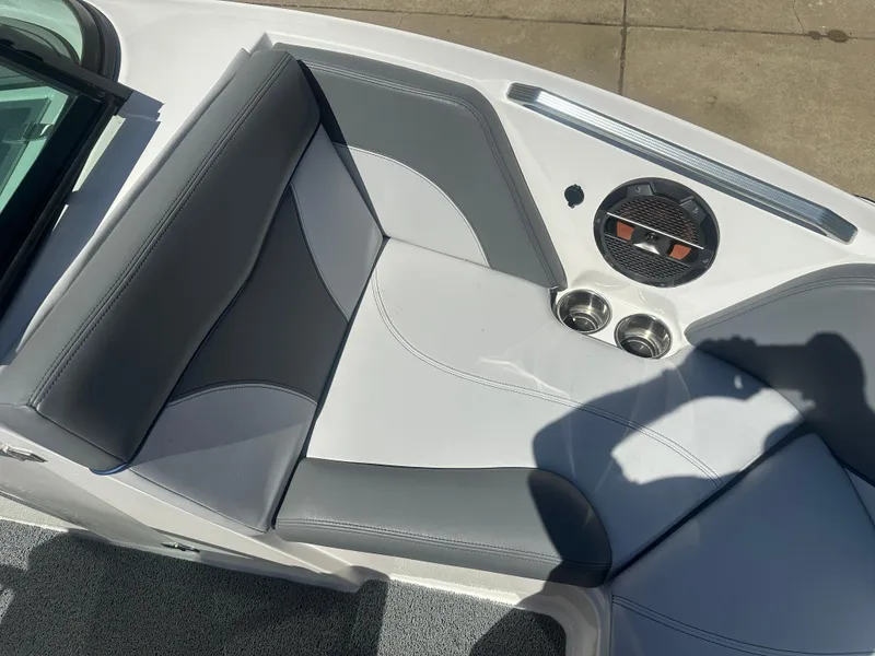 Slide: The Image of 2020 MasterCraft XT20 boat interior with gray seating and cup holders. - 16