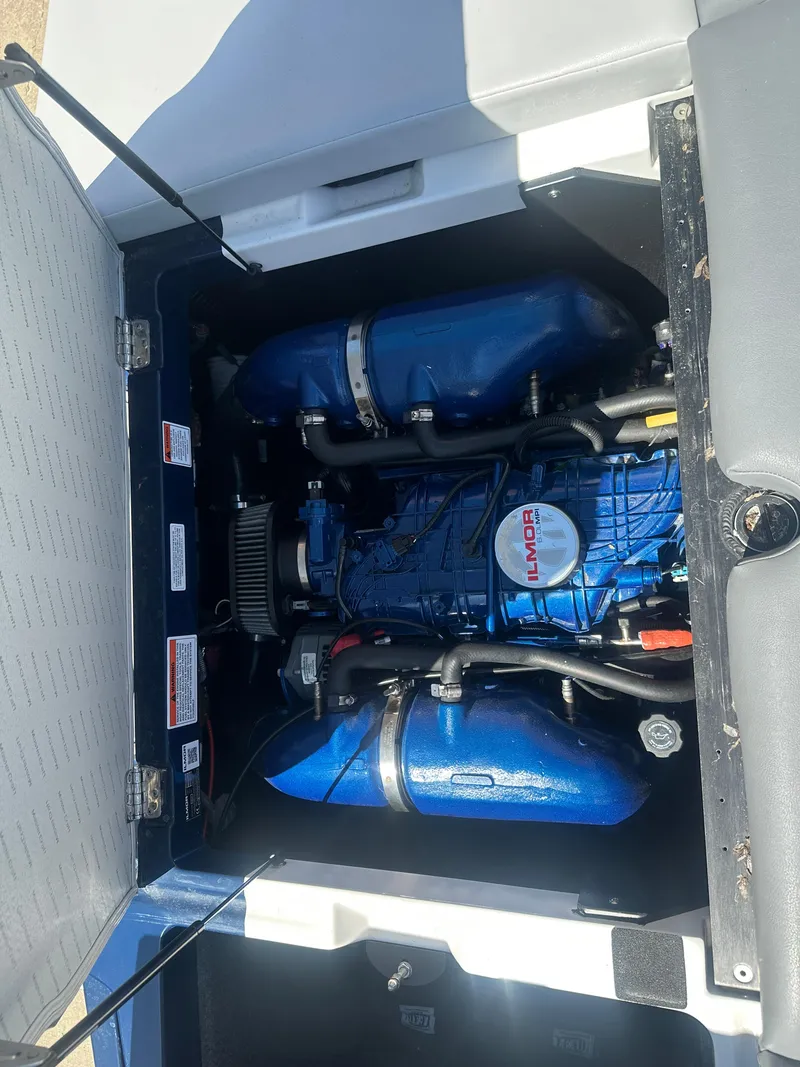 Slide: The Image of 2020 MasterCraft XT20 engine compartment with blue components and Indmar branding. - 17