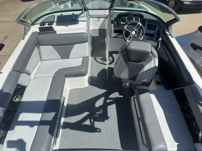 Slide: The Image of 2020 MasterCraft XT20 boat interior with gray seating and modern dashboard. - 3