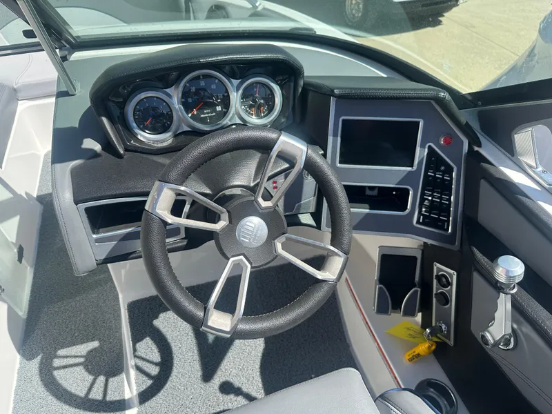 Slide: The Image of 2020 MasterCraft XT20 boat dashboard with steering wheel and control panel. - 4
