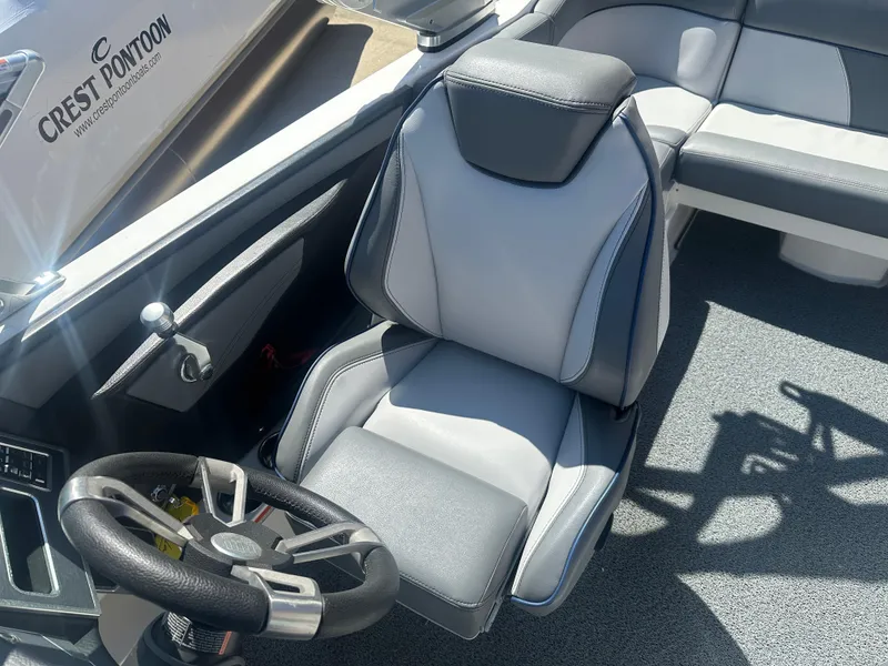 Slide: The Image of 2020 MasterCraft XT20 boat interior with sleek captain's chair and steering wheel. - 7