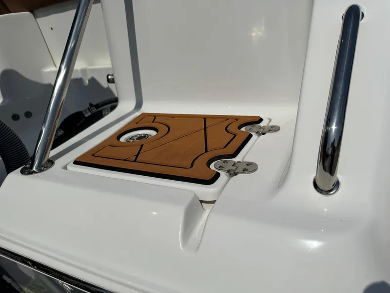 Slide: The Image of 2022 Sea Hunt Ultra 234 boat detail with stainless steel rails and teak-style deck panel. - 11