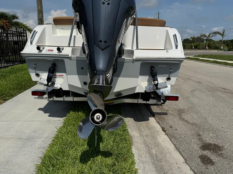 Slide: The Image of 2022 Sea Hunt Ultra 234 boat rear view with outboard motor and propeller. - 13