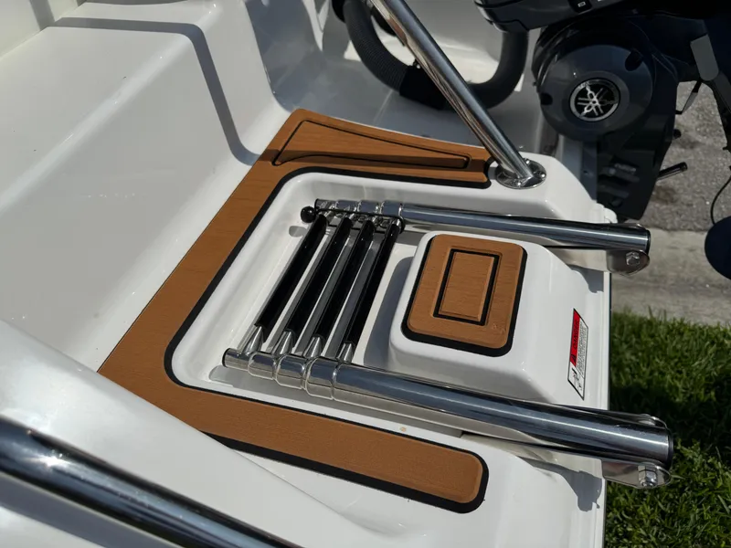 Slide: The Image of 2022 Sea Hunt Ultra 234 boat ladder and deck detail with stainless steel finish. - 16