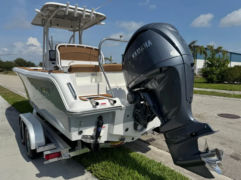 Slide: The Image of 2022 Sea Hunt Ultra 234 boat with Yamaha outboard motor on a trailer. - 18