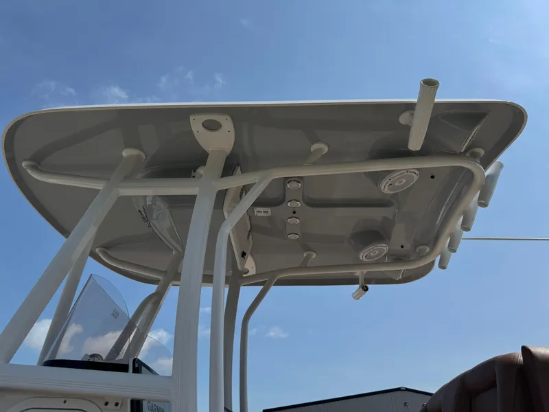 Slide: The Image of 2022 Sea Hunt Ultra 234 boat T-top against blue sky. - 21