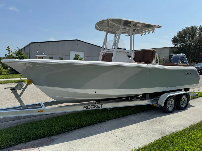 Slide: The Image of 2022 Sea Hunt Ultra 234 boat on trailer, parked outdoors. - 22