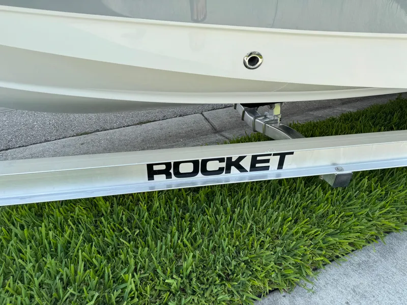 Slide: The Image of 2022 Sea Hunt Ultra 234 boat on Rocket trailer, parked on grass. - 23