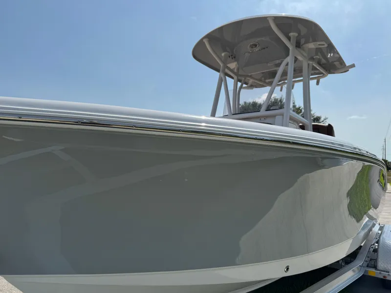 Slide: The Image of 2022 Sea Hunt Ultra 234 boat, sleek design, side view, clear sky background. - 24