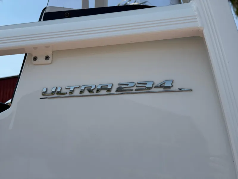 Slide: The Image of 2022 Sea Hunt Ultra 234 boat emblem on white surface. - 28