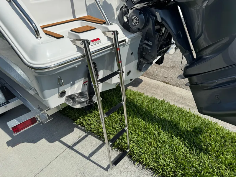Slide: The Image of 2022 Sea Hunt Ultra 234 boat with ladder and Yamaha outboard motor. - 30