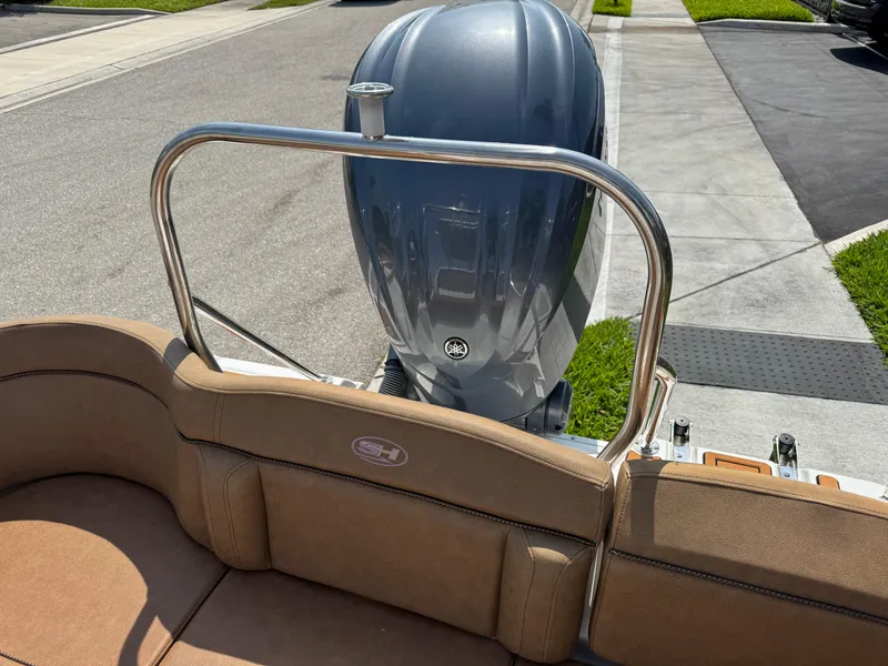 Slide: The Image of 2022 Sea Hunt Ultra 234 boat with Yamaha outboard motor, parked on a sunny street. - 31