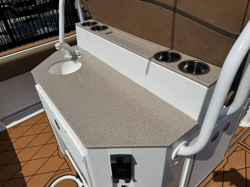 Slide: The Image of 2022 Sea Hunt Ultra 234 boat console with sink and cup holders. - 34