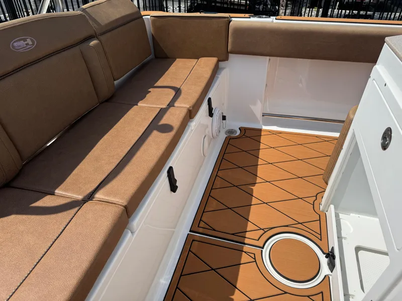 Slide: The Image of 2022 Sea Hunt Ultra 234 boat interior with brown seating and patterned flooring. - 35