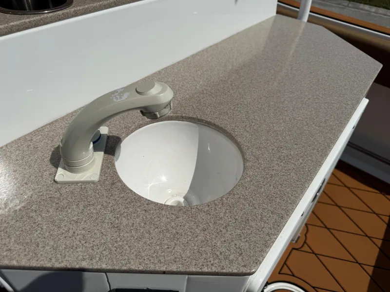 Slide: The Image of Boat sink and faucet on 2022 Sea Hunt Ultra 234, featuring a sleek countertop design. - 37