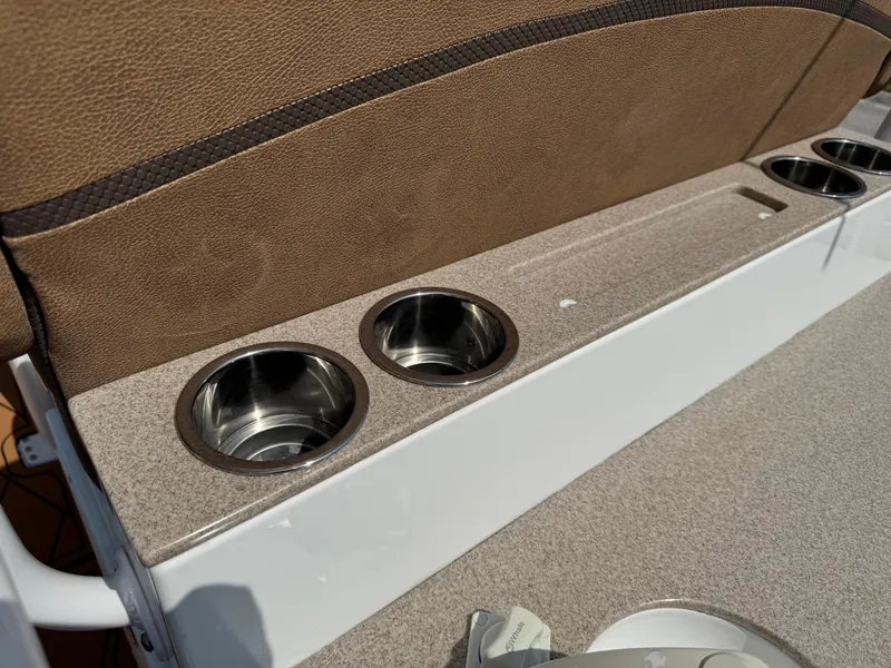 Slide: The Image of Cup holders on a 2022 Sea Hunt Ultra 234 boat with brown seating. - 38
