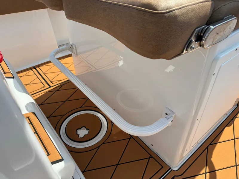 Slide: The Image of 2022 Sea Hunt Ultra 234 boat interior with brown cushioned seating and non-slip flooring. - 41